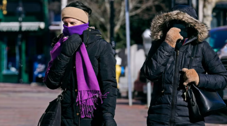 people walking on the street feeling cold